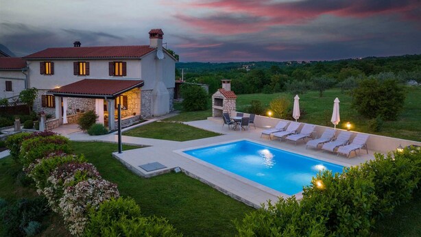 A house with a swimming pool, outdoor seating, and a stone barbecue area. - Casa Ivanovac with pool and large front yard (Rogočana)