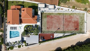 An aerial view of a property with a swimming pool, tennis court, and multiple buildings with red roofs. - Mediterranean villa Anatai with a sea view (Drenje)