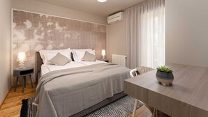 Ein modernes Schlafzimmer mit Bett, Nachttischen, einem Schreibtisch und einer Topfpflanze.