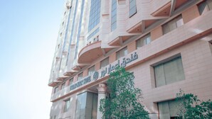 A multi-story hotel with a modern architectural design, featuring large windows and balconies. - EMMAR AL NOOR (Makkah)