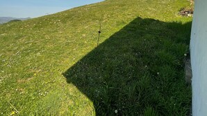A grassy hill with a clear sky. - Casa El Collau (Sevares)