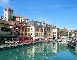 A riverside town with historic buildings, a tower, and a bridge. - COSY HOME, Annecy Rent Lodge (Annecy)