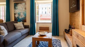 A modern living room with a sofa, a coffee table, and a view of the outside. - OURAL, Annecy Rent Lodge (Annecy)