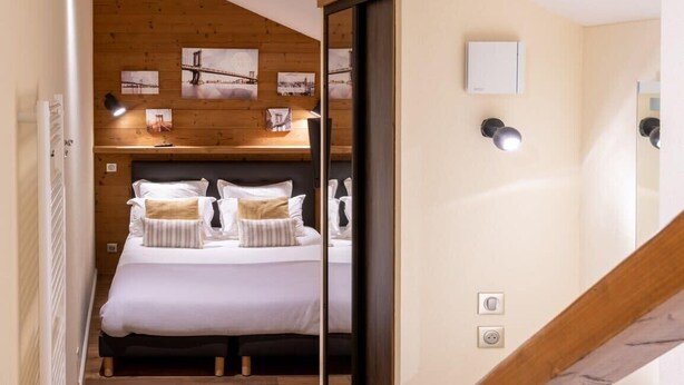 A bedroom with a bed, bedside tables, and a view of a bathroom. - APPENNINS, Annecy Rent Lodge (Annecy)