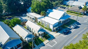 An aerial view of a residential area with houses, a parking lot, and a street. - The Jesse: Cottage in Historic Downtown Pensacola (Pensacola)