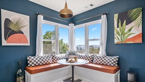 A corner seating area with a table, a bottle, and a laptop.