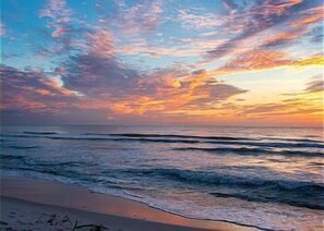 Enjoy a serene beach experience with gentle waves lapping at the shore.