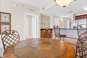 Enjoy meals around the central dining table surrounded by comfortable seating for four.
