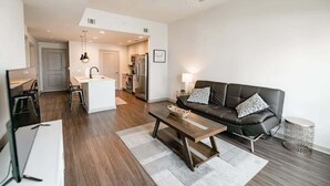 A modern living room with a sofa, coffee table, and a ceiling fan.