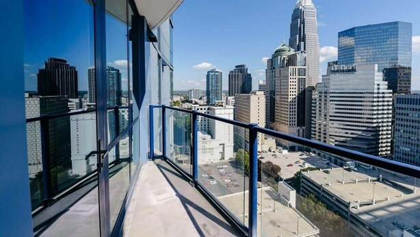 A high-rise building with large windows and a cityscape view.