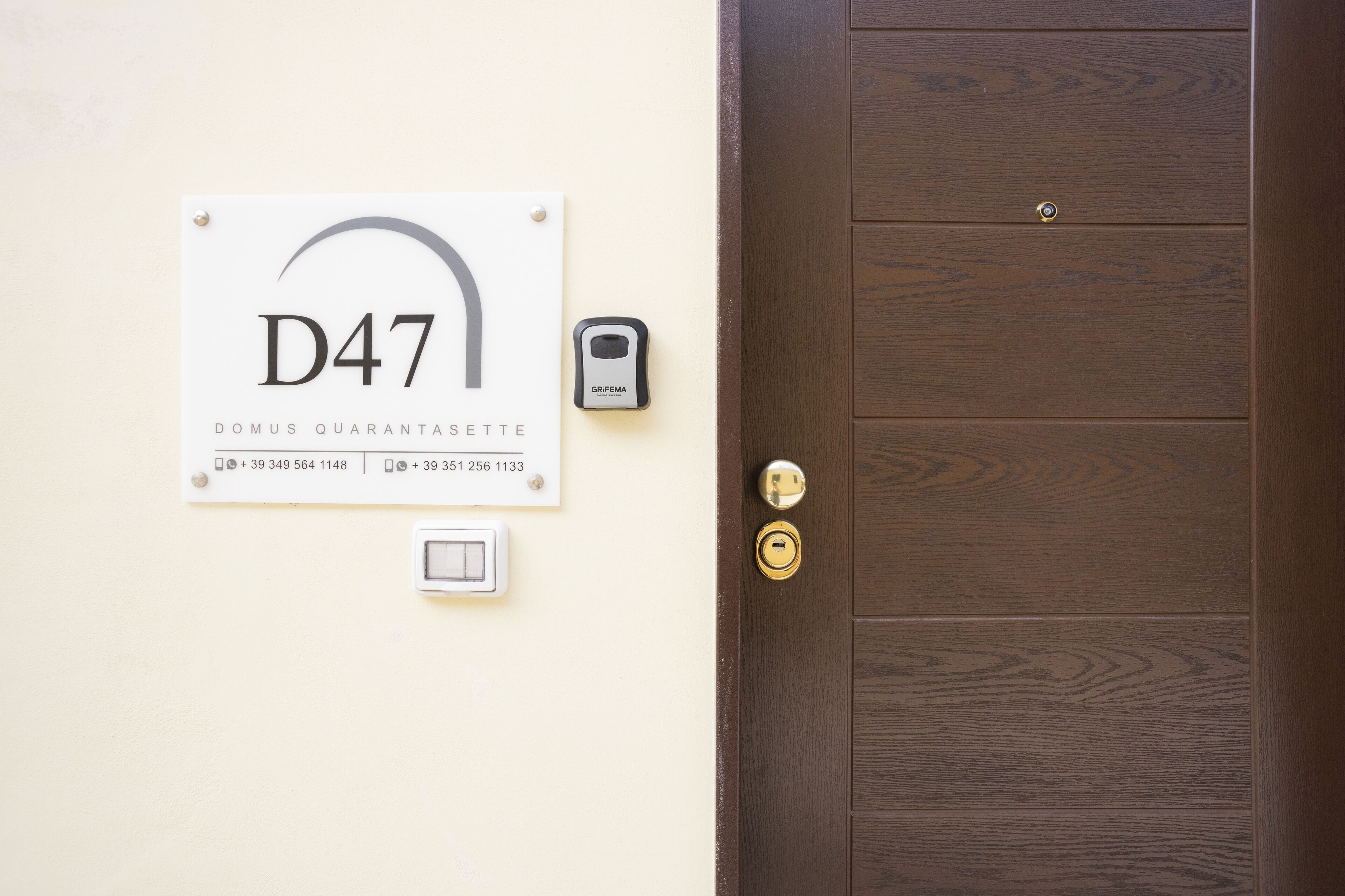 A door with a wooden panel design and a keyhole.