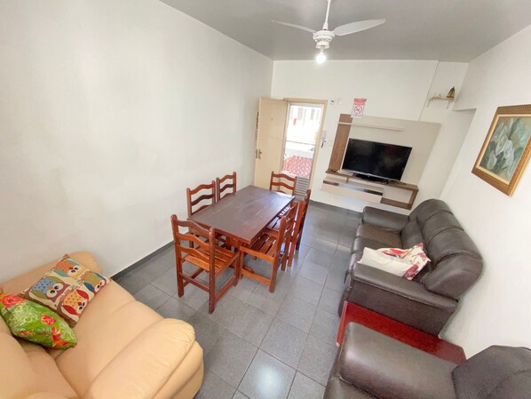 Cozy living space with a dining area, flat-screen TV, and comfortable seating.