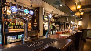 A bar area with multiple taps, including Foster's and Guinness, and a sign reading "The Sun Inn Wolverhampton."