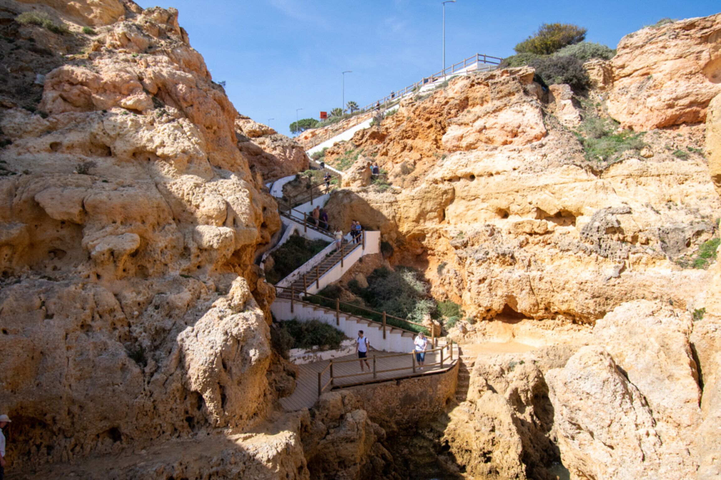 A rocky terrain with a staircase leading up to a higher elevation.