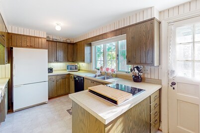 Classic country retreat with a game room, bar, expansive outdoor space, & grill