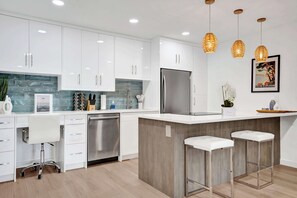 Fridge, stovetop, dishwasher, coffee/tea maker