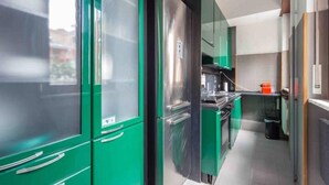 A modern kitchen with green cabinetry, stainless steel appliances, and a clean, organized layout. - Enjoy a stay in the Vittoria home just 15 minutes from Milan Cathedral. (Milano)
