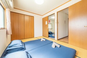 A hotel room with a bed, a wardrobe, and a mirror. - DoumoTengachaya (Osaka)