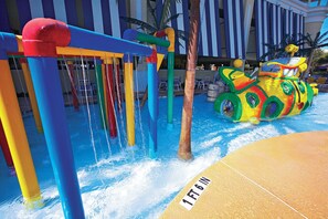 A water play area with a slide and a water jet feature.