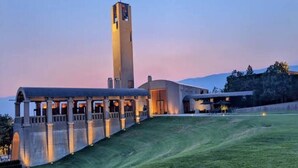 A building with a prominent tower and a covered walkway.