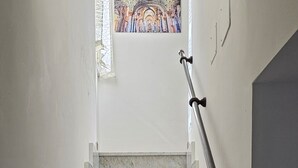 A staircase with marble steps and a handrail, leading to a stained glass window above. - CALA APARTAMENT (Palermo)