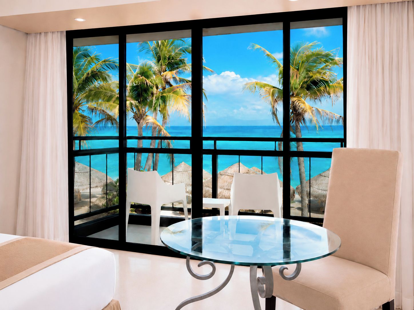 A room with a glass table and chairs, large windows with a view of the sea and palm trees.