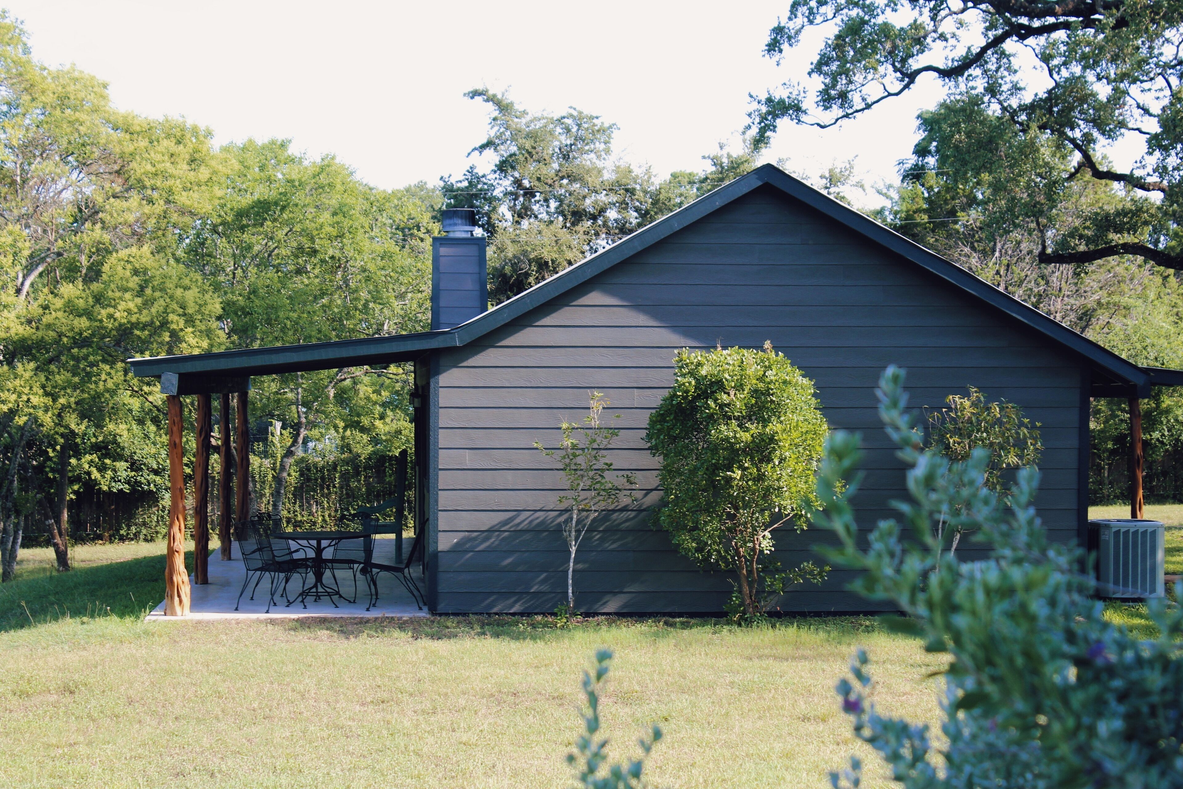A single-story building with a covered porch and a chimney.