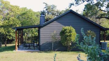 A single-story building with a covered porch and a chimney.