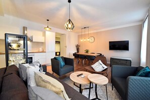Deluxe Apartment | Living area | 42-inch LCD TV with cable channels