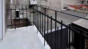 A multi-story residential building with balconies, a gated entrance, and a street in front. - Moin - Moin Apartment and Suite Zagreb (Zagreb)