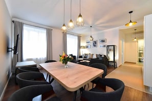 Deluxe Apartment | Living area | 42-inch LCD TV with cable channels