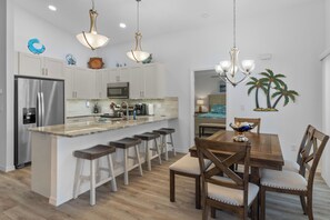Enjoy cooking in this well-lit kitchen with a central island and bar stools.