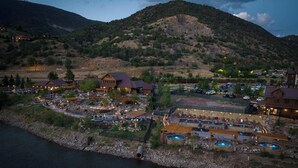 A resort with multiple buildings, outdoor pools, and a river.