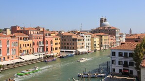 A canal with boats, historic buildings, and a prominent dome structure. - Apartment Altana, Amazing Grand Canal View (Venecia)