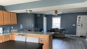 A spacious kitchen with a dining area, wooden cabinets, and a large island. - Luxury Townhome #2  - Remodeled Feb 2021 (Bloomington)