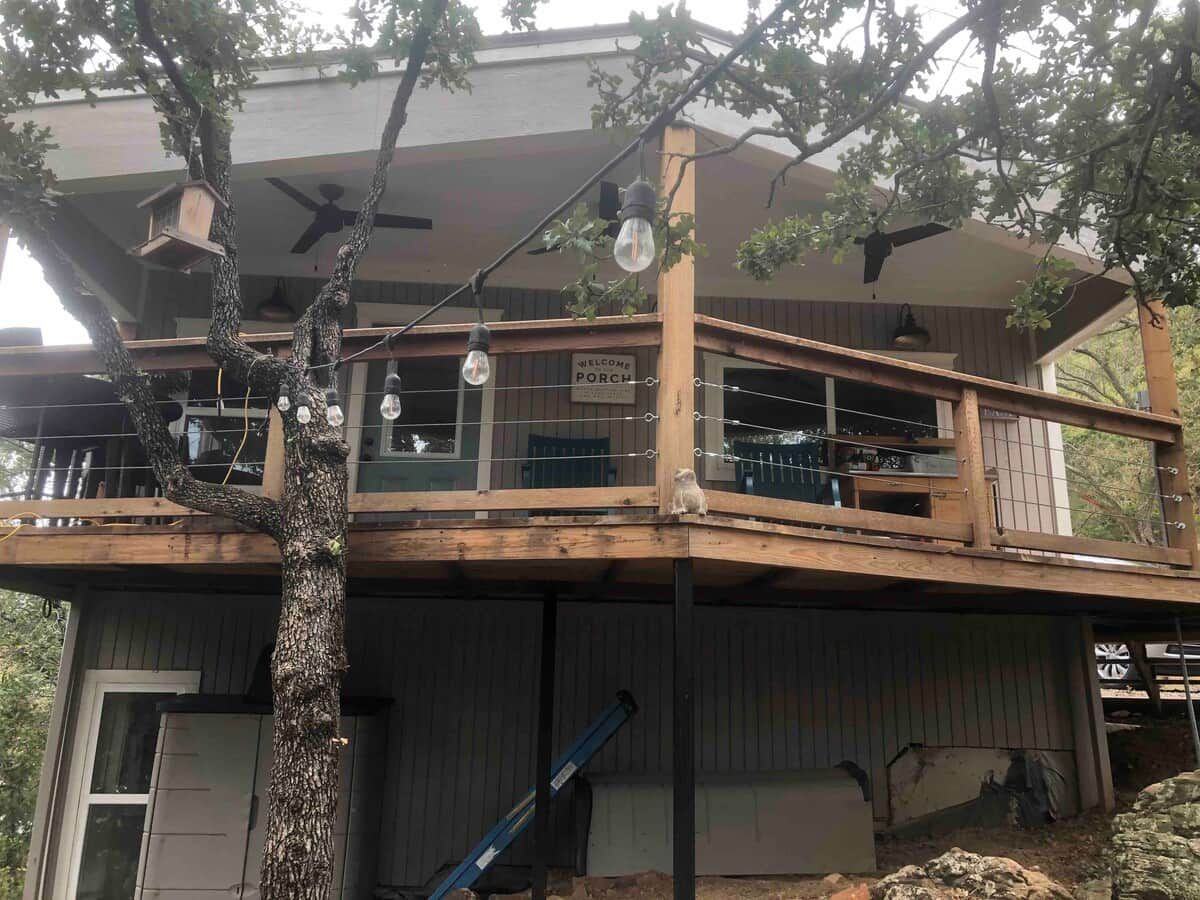 A two-story building with a balcony and a porch.