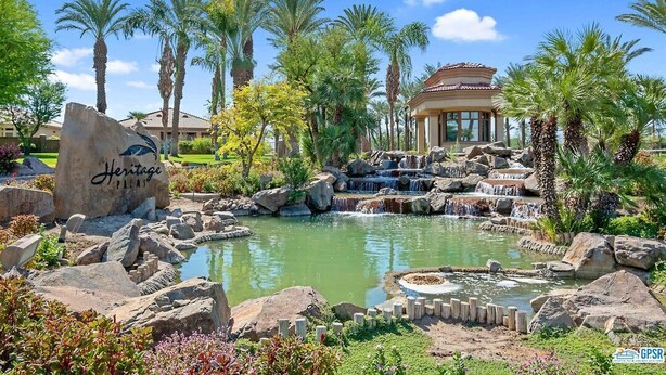 A resort with a water feature, palm trees, and a building with a red roof. - Casa Royal Troon- Active 55+ Golf Course Community, Private Home w Pool and Spa! (Indio)