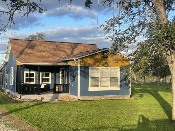 A single-story house with a front porch, a garage, and a well-maintained lawn.