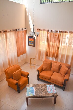 Relax in this inviting living area with a comfortable sofa, armchair, and coffee table.
