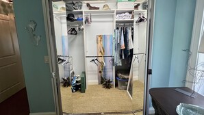 A walk-in closet with shelves, hanging space, and a pet bed. - Cozy beach home! Private pool, 2min walk to beach, walkable to restaurants/shops (New Smyrna Beach)