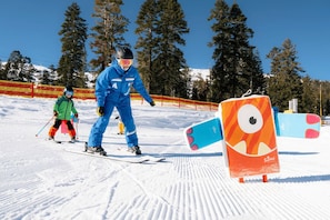 A ski slope with skiers and a colorful inflatable structure. - Room with Slopeside Access | Complimentary Wi-Fi (Kirkwood)