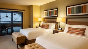 A hotel room with two beds, a sofa, and a view of a ski lift. - Lovely Room + Kitchenette | Ski-in/Ski-out (Park City)