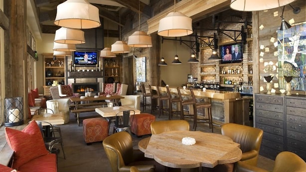 A cozy bar area with leather seating, a fireplace, and a television screen. - Room with Ski-in/Ski-out Access | Rooftop Hot Tub (Park City)