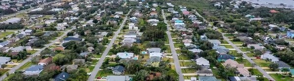 An aerial view of a residential area with houses, roads, and greenery. - Oh Buoy! Bungalow- Family & Pet Friendly Beach House (Saint Augustine)
