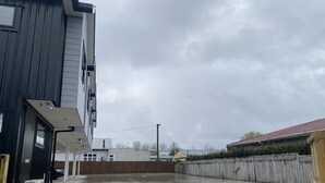 A parking lot with a wet surface, likely from recent rain. - Norton Motel (Hamilton)