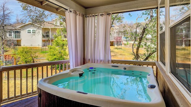 A hot tub on a wooden deck with a view of houses and trees. - Beautifully furnished home with HOT TUB (Angels Camp)