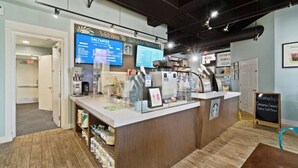 A coffee shop interior with a wooden counter, menu boards, and a Starbucks sign.