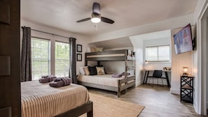 A bedroom with a bunk bed, a desk, and a chair. - Your Seaside Sanctuary on Ocean Drive Awaits (Corpus Christi)