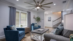 A living room with two sofas, a coffee table, and a ceiling fan. - Your Seaside Sanctuary on Ocean Drive Awaits (Corpus Christi)