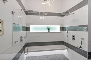 Bathtub, hair dryer, towels, shampoo